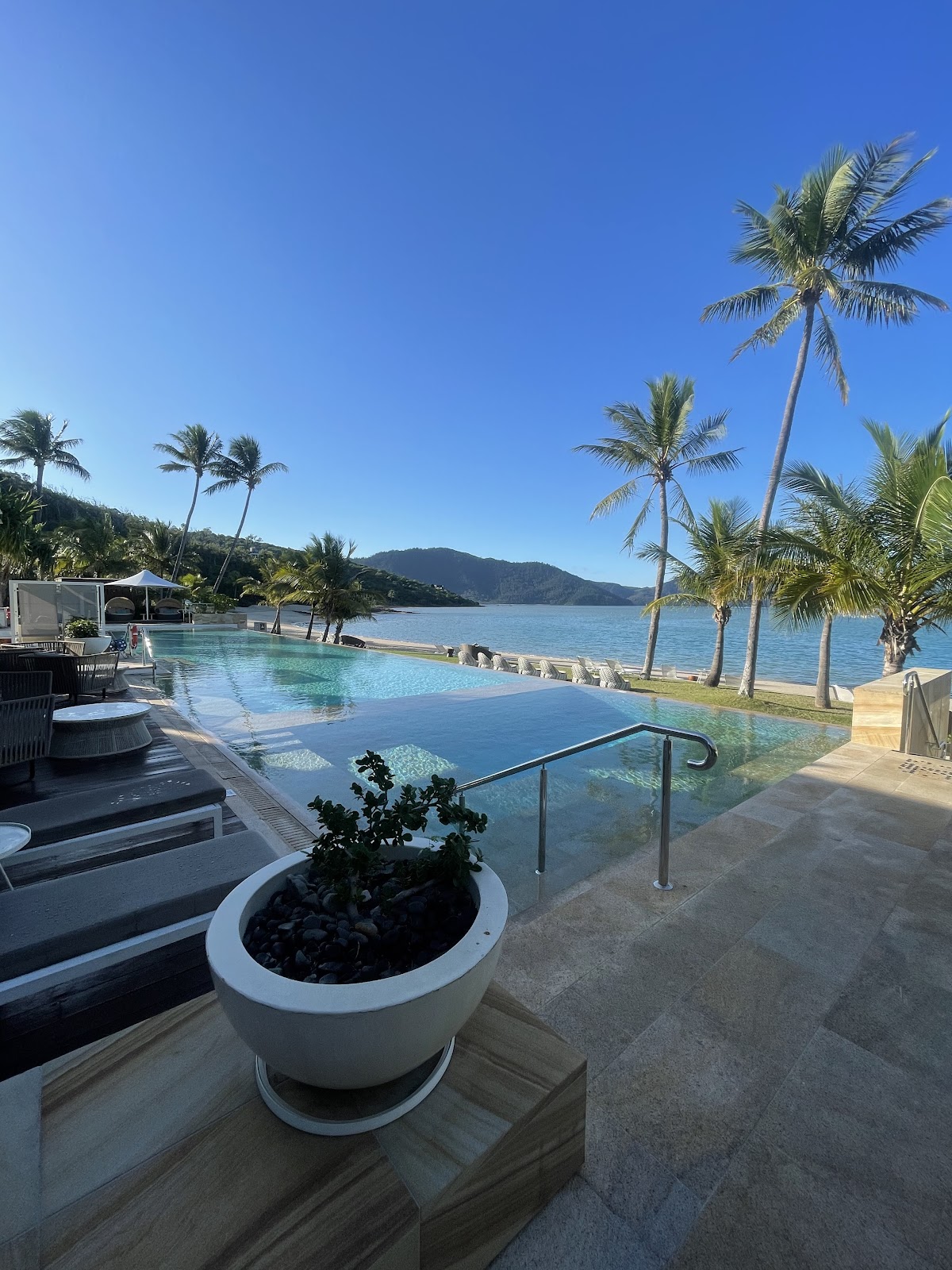 Resort infinity edge pool looking out over a tropical bay