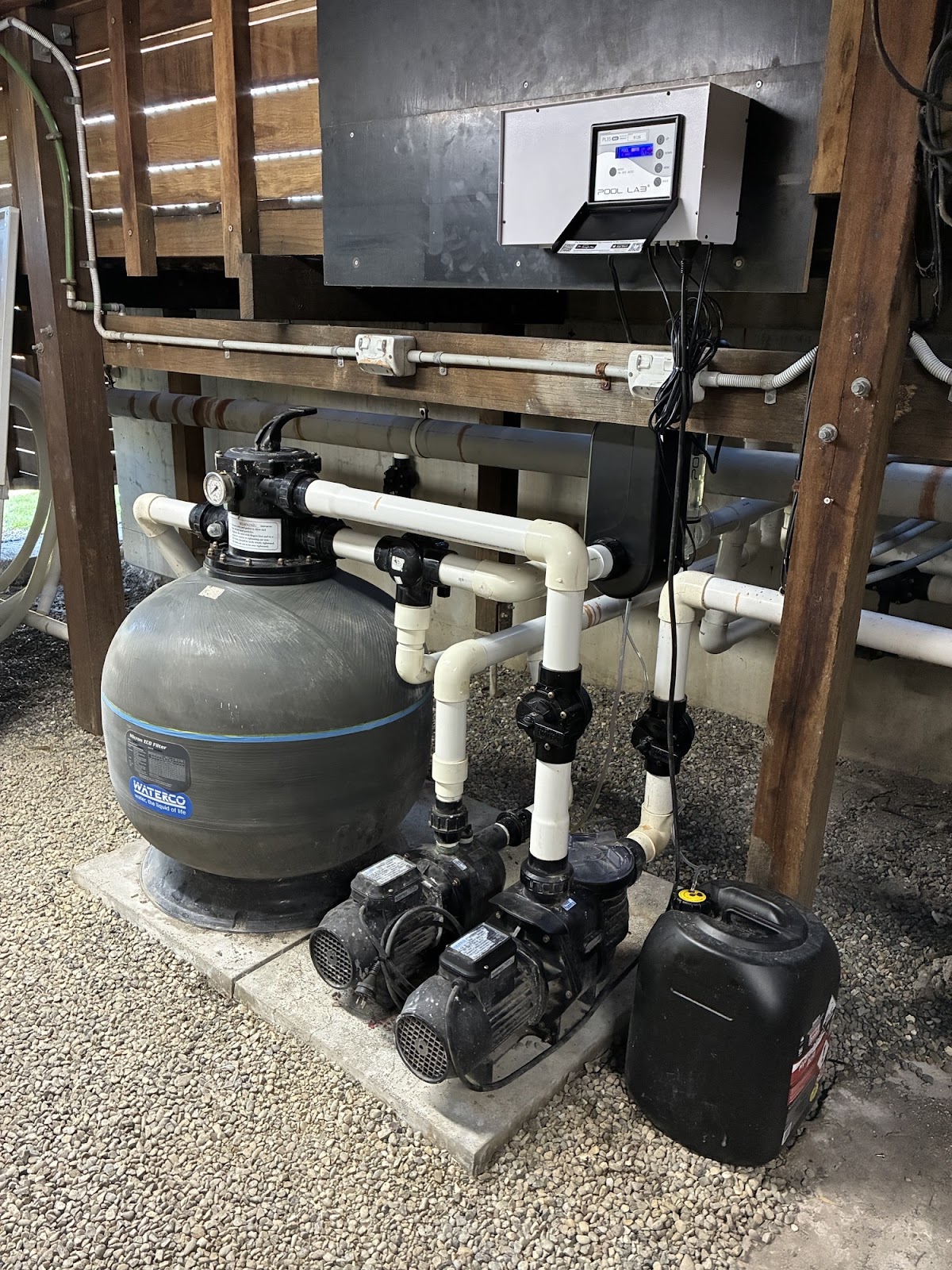 Sand filter, twin pumps and chlorinator control under a timber deck