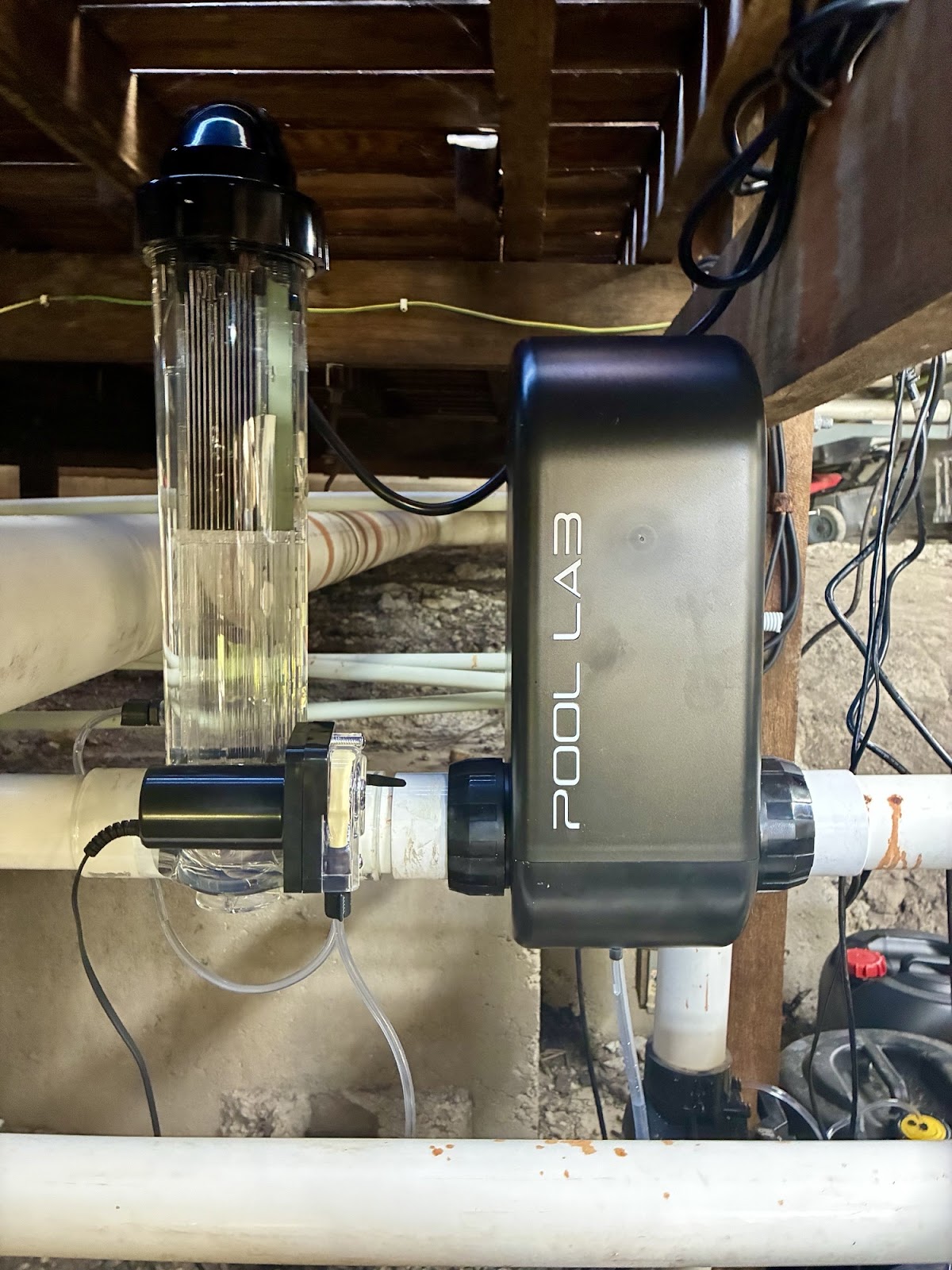 Water treatment unit and clear cell mounted on white pool pipework