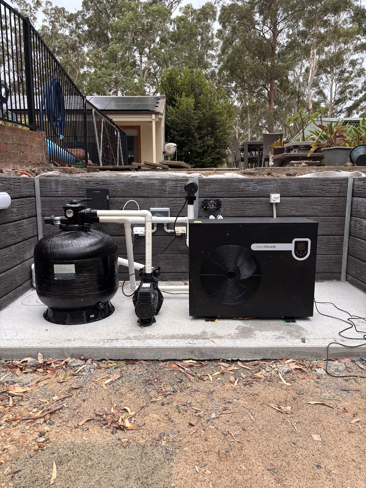 Filter, pump and heat pump on a fresh concrete slab
